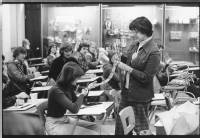 Dr. Helain Minkus showing Native American artifacts to students, ca, 1970s